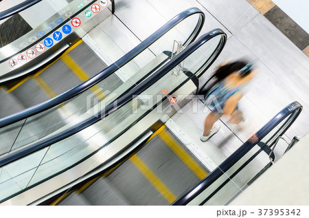 People rush on escalator motion blurred People rush on escalator motion blurred 37395342