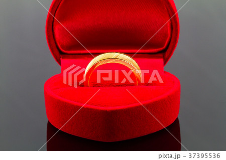 Gold ring in red heart shaped velvet  box 37395536