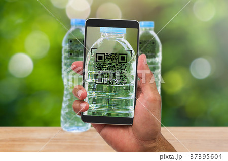 Hands holding smartphone scanning QR code 37395604