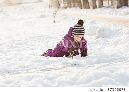 Kid plays on the snow Kid plays on the snow 37396073