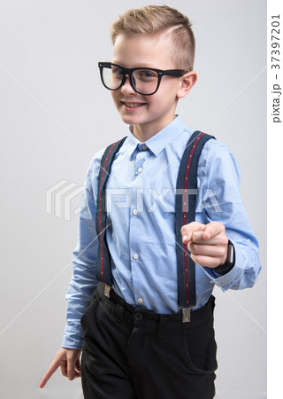Trendy schoolboy gesturing with coquettish 37397201