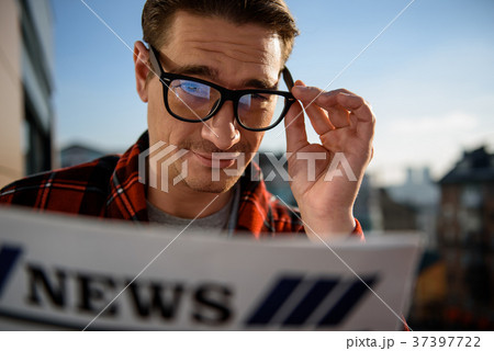 Serene adult male standing outside with the 37397722