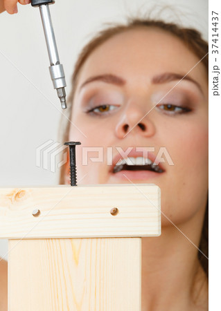Woman assembling wooden furniture. DIY. Woman assembling wooden furniture. DIY. 37414437