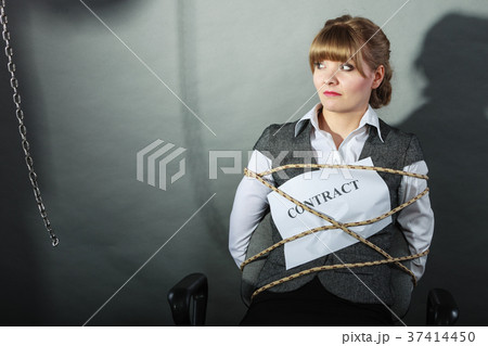 Upset businesswoman bound by contract terms. Upset businesswoman bound by contract terms. 37414450