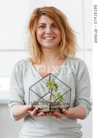 Picture of florist girl with florarium with stones 37416190