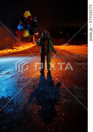 Picture clown with balls in hands at night 37416273