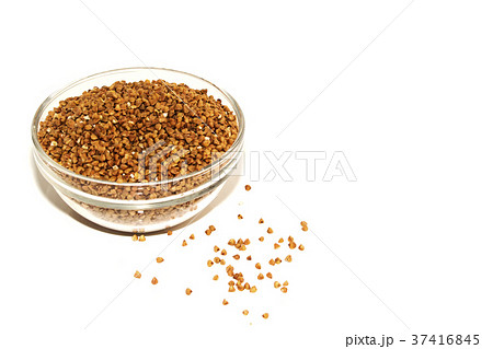 buckwheat in a glass bowl isolated on white. 37416845