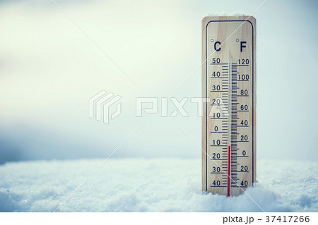 Thermometer on snow shows low temperatures. 37417266