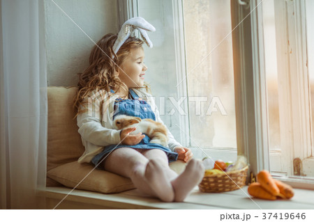 Cute happy little child girl is wearing bunny ears 37419646