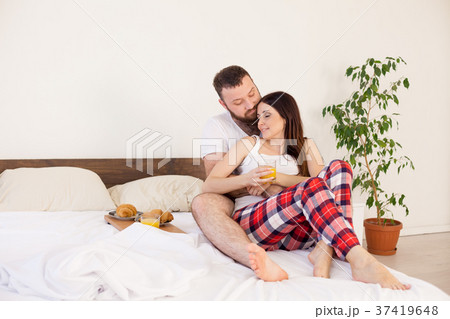 a man with a woman breakfast in bed in the morning 37419648