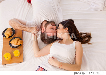 a man with a woman breakfast in bed in the morning 37419668