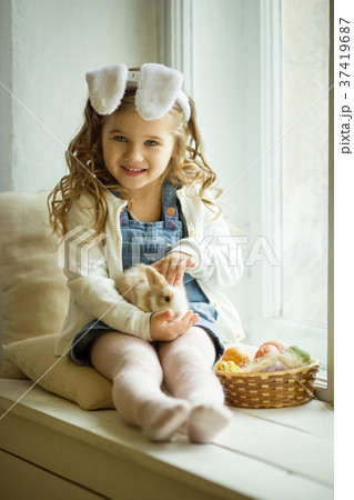Cute happy little child girl is wearing bunny ears 37419687
