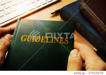 Hands holding Guidelines in an office. Hands holding Guidelines in an office. 37424570