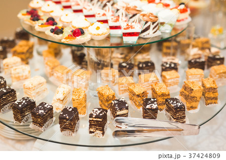 Delicious and tasty dessert table with cupcakes 37424809