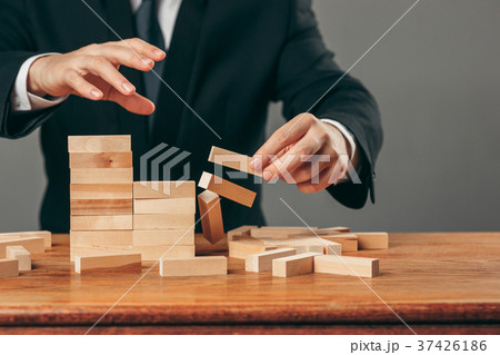 Man and wooden cubes on table. Management concept Man and wooden cubes on table. Management concept 37426186