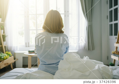 Woman stretching in bed after wake up,flare light Woman stretching in bed after wake up,flare light 37426396