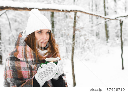 girl in a white hat wrapped in a rug holds a mug girl in a white hat wrapped in a rug holds a mug 37426710
