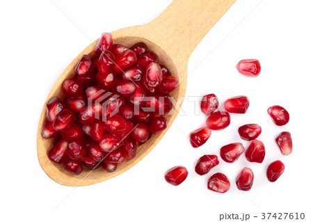 pomegranate seeds in wooden spoon isolated on 37427610