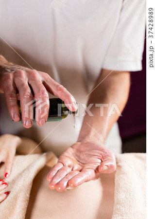 close-up pours oil in the palm. Osteopath doing 37428989