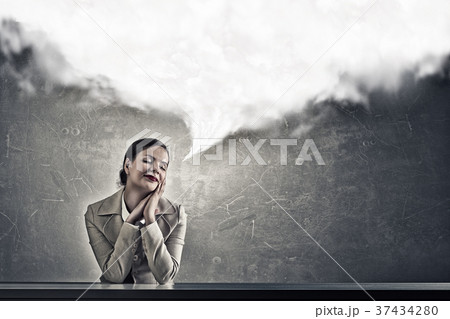 Attractive businesswoman sitting at table Attractive businesswoman sitting at table 37434280