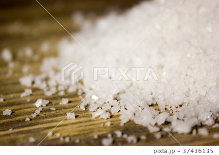 Large sea salt on wooden background Large sea salt on wooden background 37436135