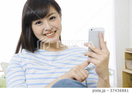 ソファでスマホをする若い女性 ソファでスマホをする若い女性 37436881