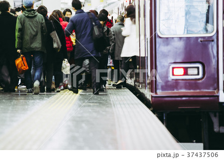 電車から降りる人々の写真素材