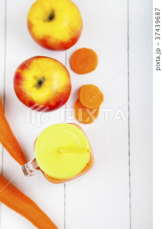 Apple-carrot juice on a wooden table. 37439687