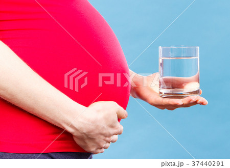 Pregnant woman with glass of water Pregnant woman with glass of water 37440291