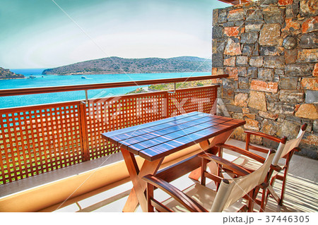 Table and chairs on balcony with sea view, Greece 37446305
