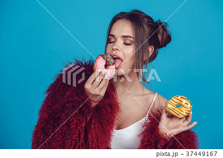 Attractive young woman in bright fur coat posing Attractive young woman in bright fur coat posing 37449167