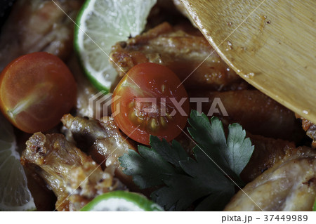 Chicken fried in skillet with wooden spatula Chicken fried in skillet with wooden spatula 37449989