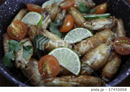 Chicken fried in skillet with wooden spatula 37450008