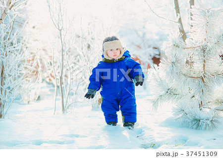 Child in the park with snow in winter Child in the park with snow in winter 37451309