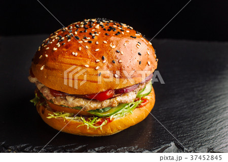 Hamburger on a black slate board. 37452845