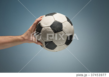 Hands holding soccer ball 37453977