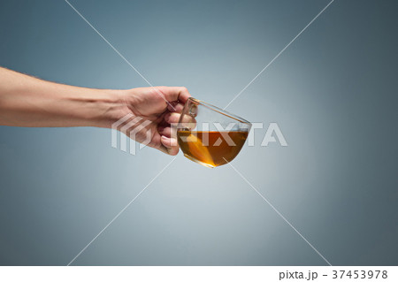 Man holding a cup of coffee 37453978