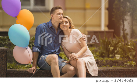 People in love sitting on bench, guy holding People in love sitting on bench, guy holding 37454038