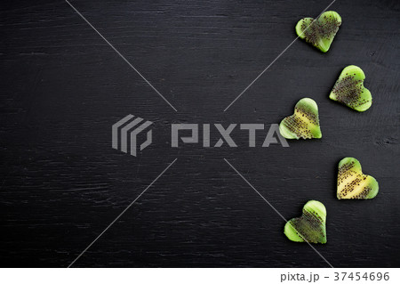 Hearts made of kiwi fruit on black background Hearts made of kiwi fruit on black background 37454696