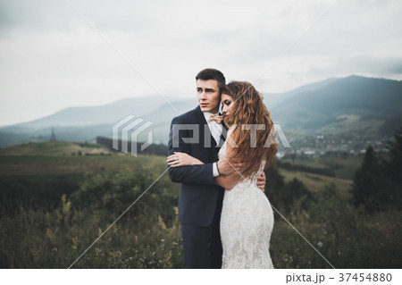 Young newly wed couple, bride and groom kissing Young newly wed couple, bride and groom kissing 37454880