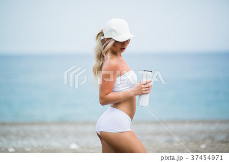 young beautiful sports girl posing with a bottle young beautiful sports girl posing with a bottle 37454971