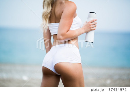 Gorgeous fit young woman with water bottle on the Gorgeous fit young woman with water bottle on the 37454972