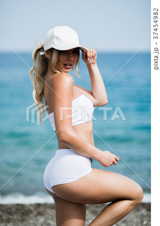 Fitness girl with a perfect body is smiling near 37454982