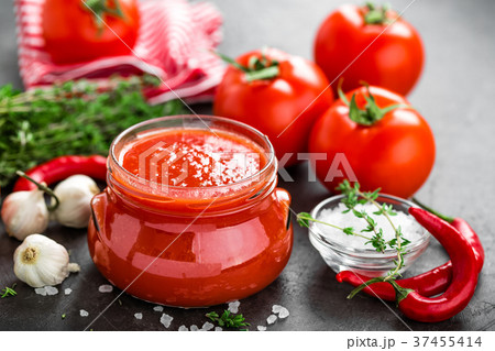 Tomato paste, puree in glass jar and fresh tomatos 37455414