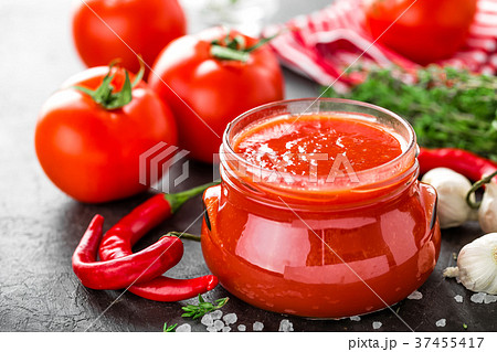 Tomato paste, puree in glass jar and fresh tomatos 37455417