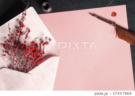 Envelope with flowers on a paper and a quill pen 37457964