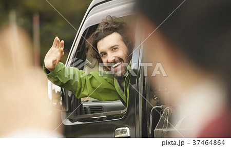 トラック 手を振る外国人男性の写真素材