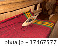 Traditional weaving and a shuttle on machine 37467577