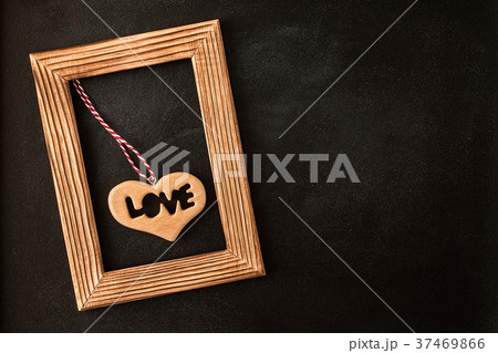 Heart in wooden  picture frame on the chalkboard 37469866