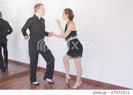 Couple of dancers dancing latin dances Couple of dancers dancing latin dances 37472011